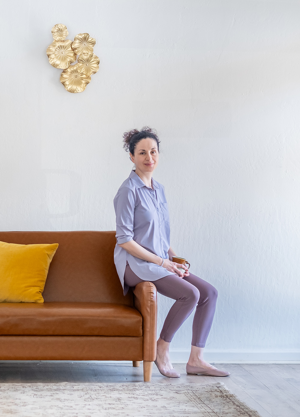 Nil sitting on the edge of a couch.